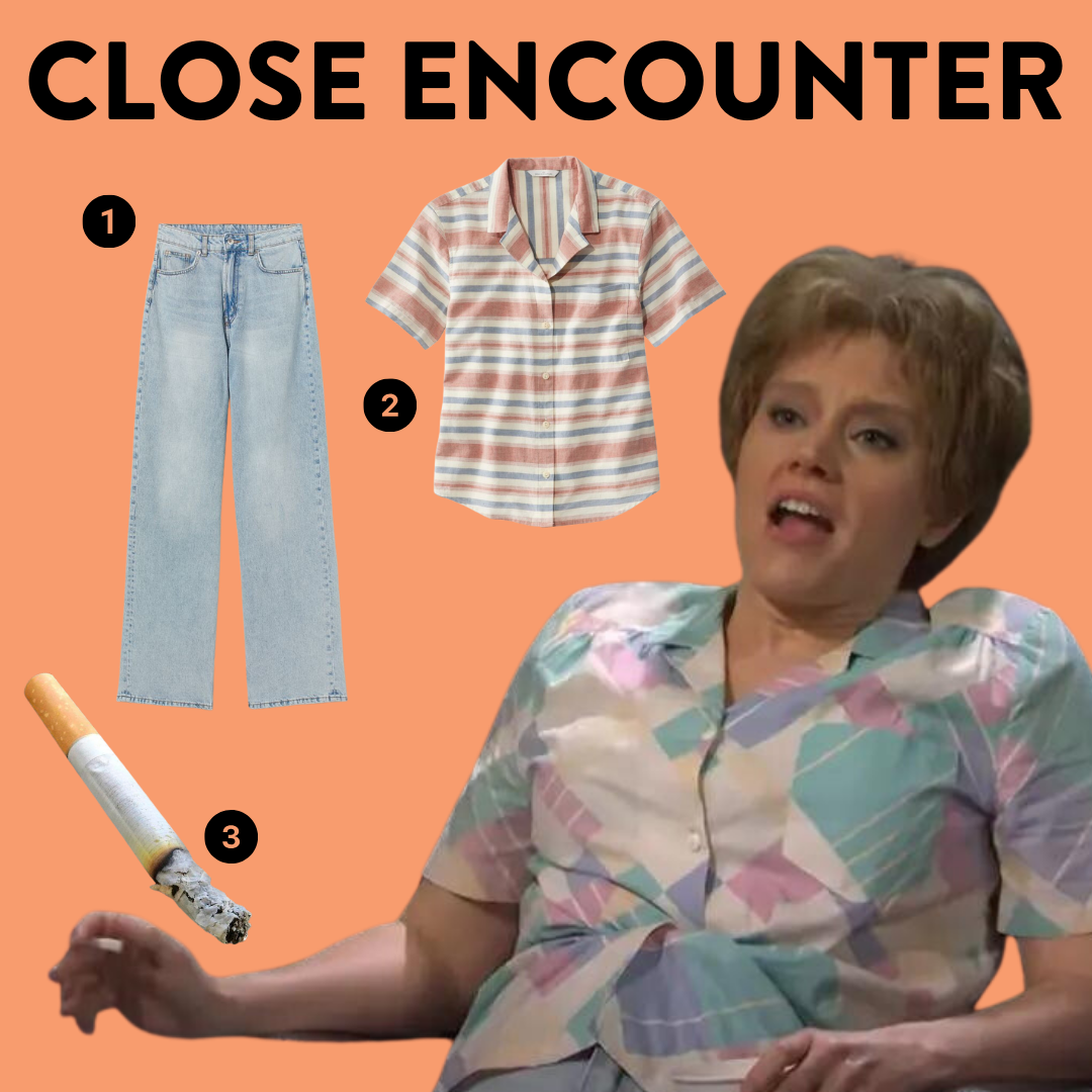 Kate McKinnon as close encounters with numbered costume elements, a plain camp shirt, light wash jeans, cigarette